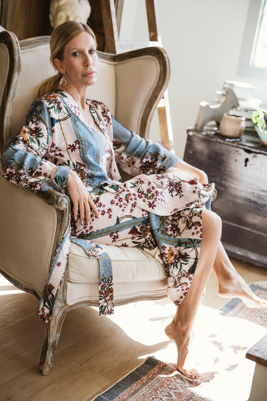 "A stunning floral kimono graced with a garden of intricate blossoms. The vibrant and detailed floral patterns cascade across the fabric, creating a visually enchanting ensemble. With a graceful drape and an airy feel, this kimono captures the essence of elegance and nature, making it a striking choice for a range of stylish looks."