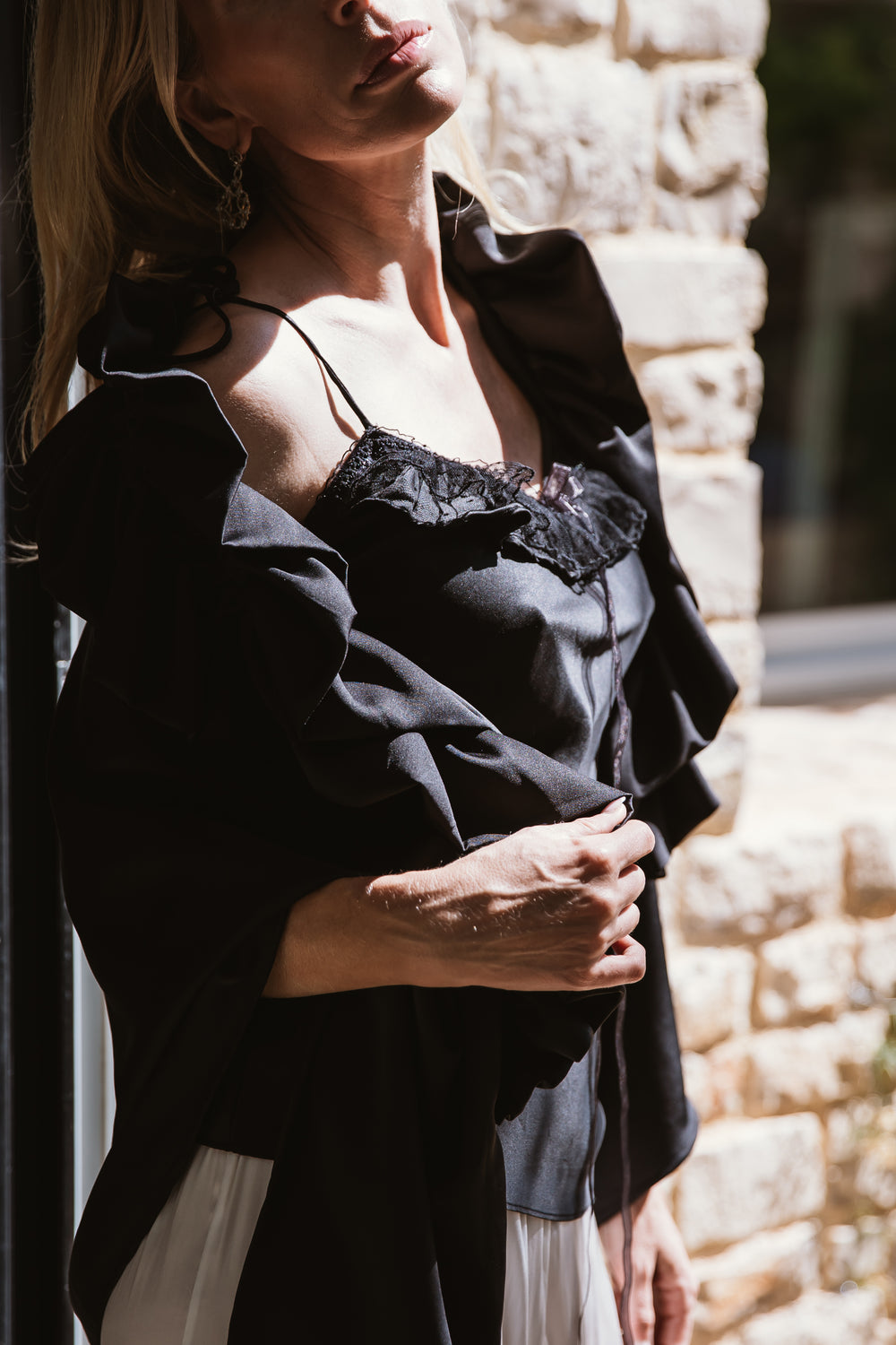 The "Rosolida Black Silk Top," a sleek and sophisticated garment. With its smooth silk texture and chic design, it effortlessly combines modern elegance with timeless allure. This top is perfect for creating a refined and versatile look, suitable for a range of occasions where you want to exude confidence and style.