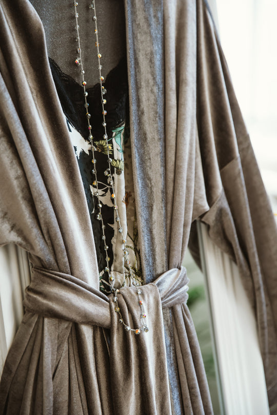  "A stylish grey kimono featuring a minimalist and versatile design. The subdued grey hue exudes sophistication, while the kimono's relaxed silhouette offers comfort and ease. This versatile piece adds a touch of modern elegance to any ensemble, making it a chic and adaptable choice for various occasions."